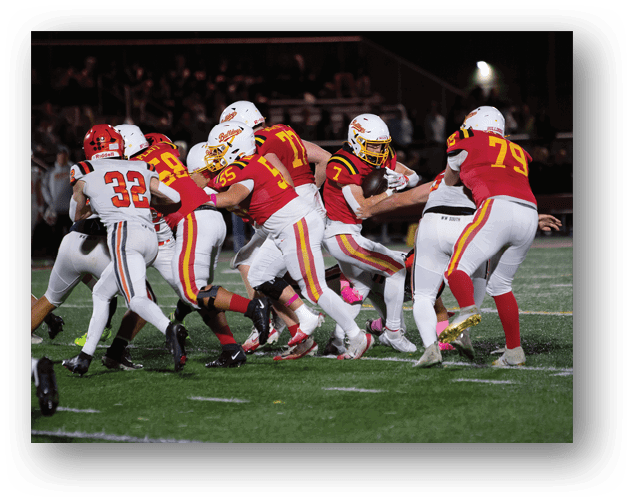 A football game is taking place on a field with players wearing blue and white uniforms. Description generated by AI