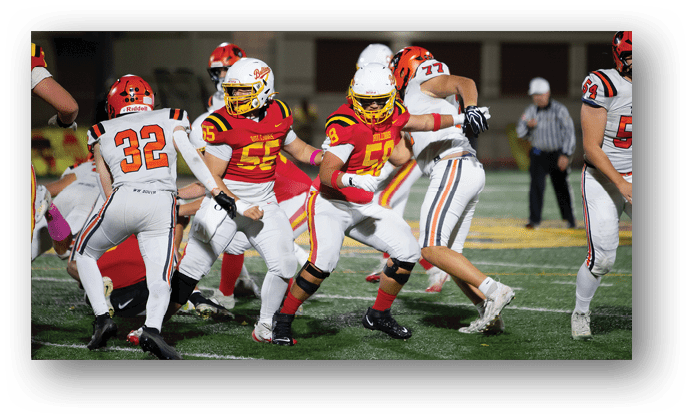 A group of football players on a field. Description generated by AI