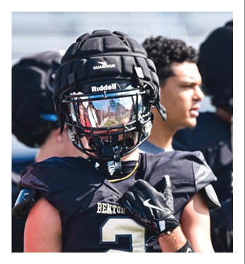 A football player wearing a helmet and jersey with the number 2 on it. Description generated by AI