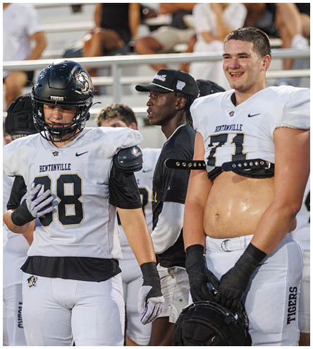A man wearing a white jersey with the number 71 on it. Description generated by AI