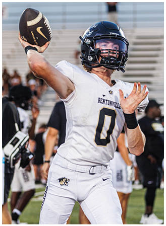 A football player in a white jersey with the number 0 on it. Description generated by AI