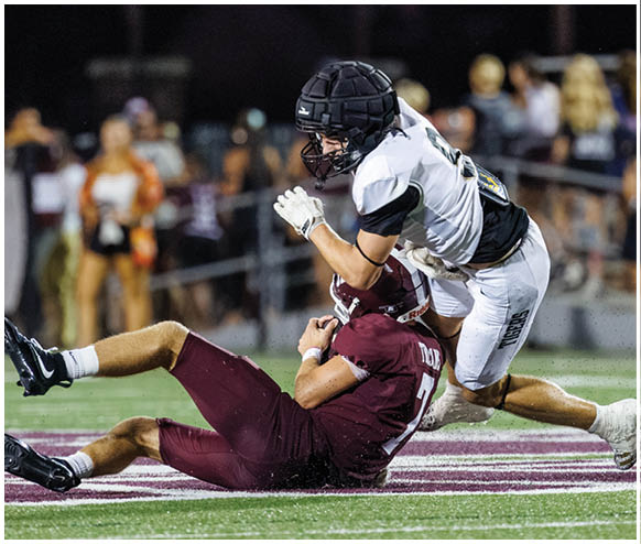 Two football players on the field. Description generated by AI