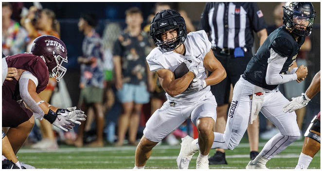 A football player in a white jersey running on the field. Description generated by AI