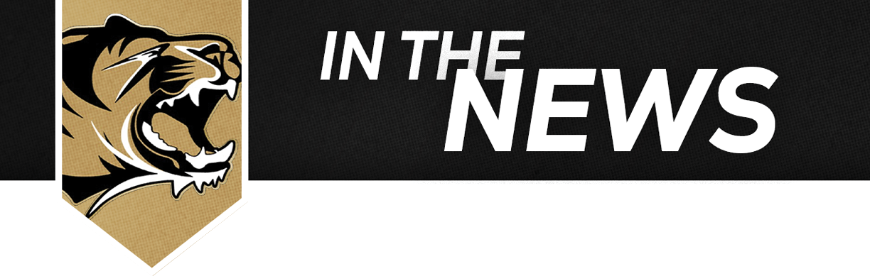 A tan colored background with a black and white text reading “In the News". Description generated by AI