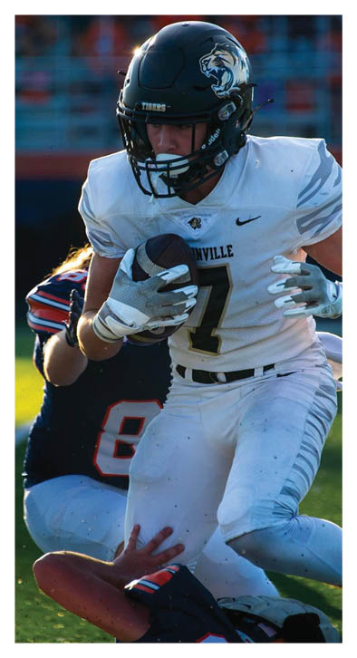 A football player in a white jersey with the number 7 on it. Description generated by AI