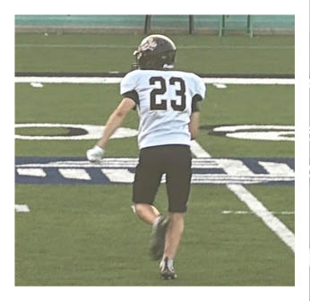 A football player running on the field. Description generated by AI