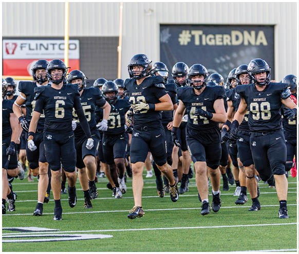 A football team is running on the field. Description generated by AI