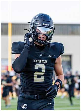 A football player wearing a black and gold jersey with the number 2 on it. Description generated by AI
