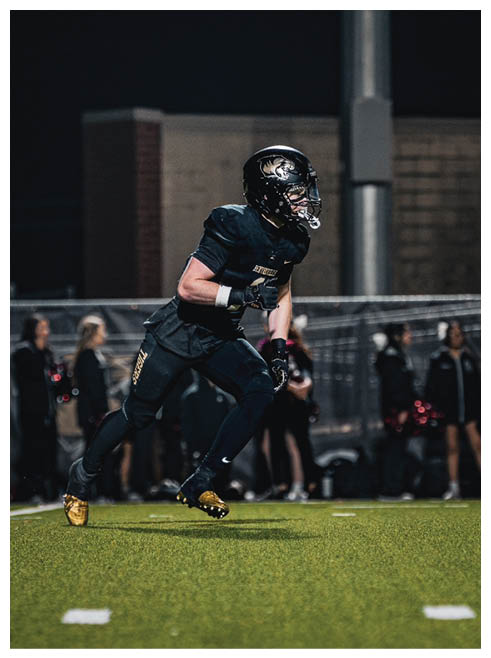 A football player running on the field. Description generated by AI