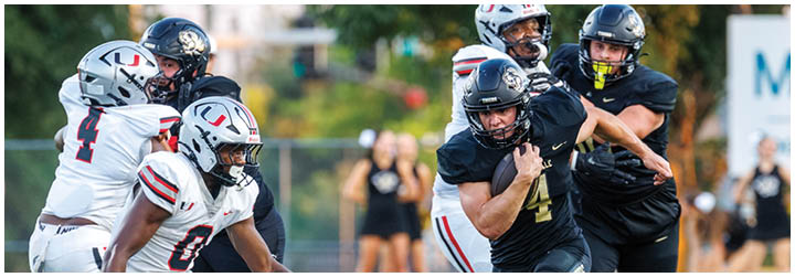A football game is taking place with two teams playing. Description generated by AI