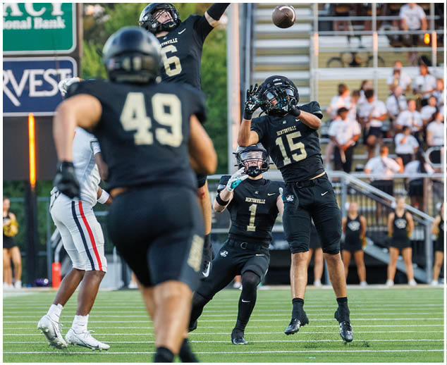 A football player catching a ball. Description generated by AI