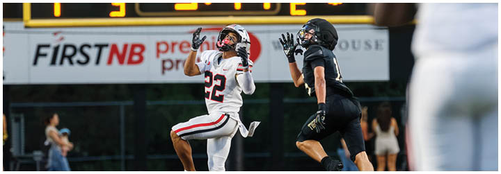 A football game is being played with a scoreboard showing the score. Description generated by AI