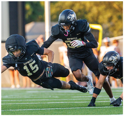 A football player slides into the end zone. Description generated by AI