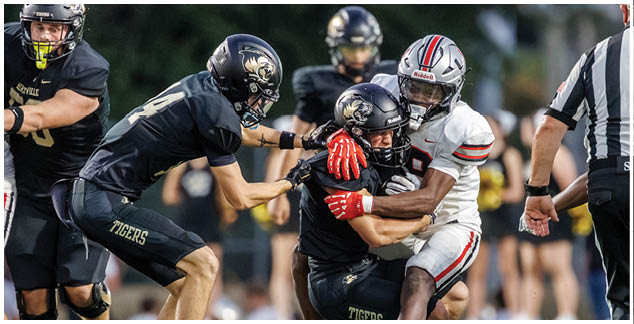 A group of football players on a field. Description generated by AI