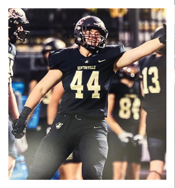 A football player wearing a black jersey with the number 44 on it. Description generated by AI