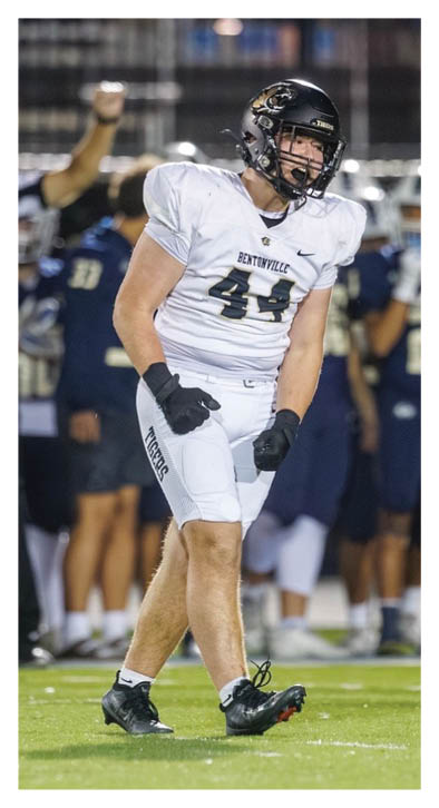 A football player wearing a white jersey with the number 44 on it. Description generated by AI