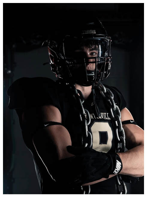A football player wearing a helmet and chains. Description generated by AI