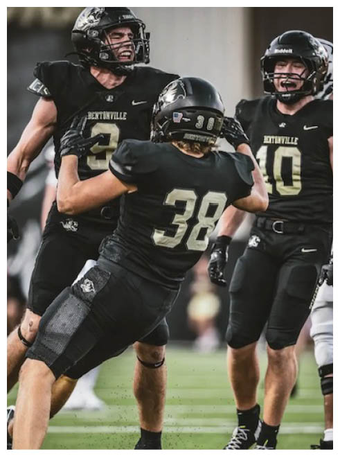 A group of football players celebrating a touchdown. Description generated by AI