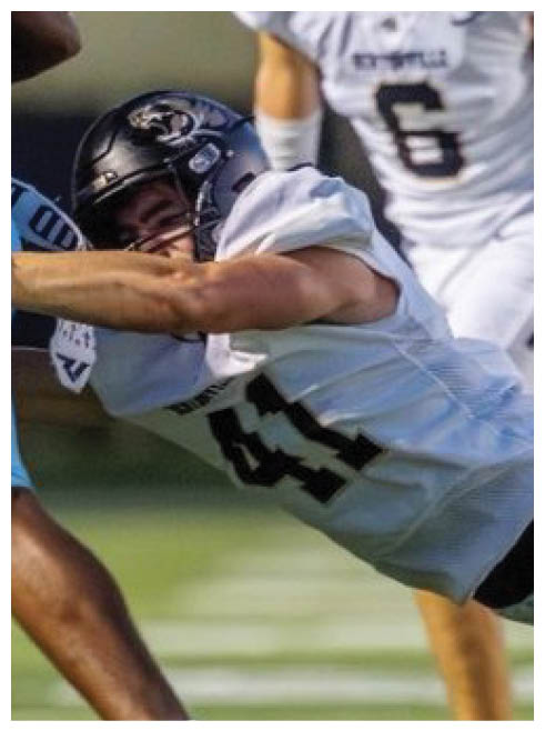 A football player is sliding on the ground. Description generated by AI