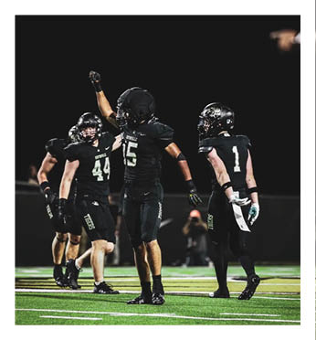 A group of football players on a field. Description generated by AI