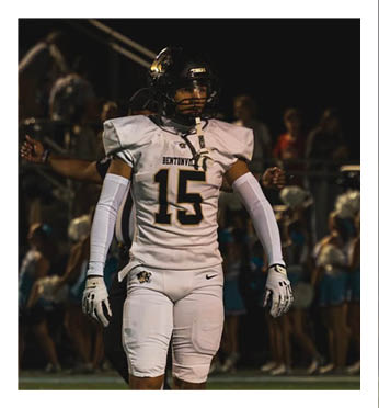 A football player wearing a white uniform with the number 15 on the back. Description generated by AI
