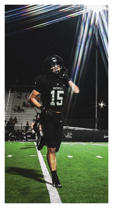 A football player running on a field at night. Description generated by AI
