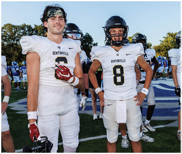 A group of football players wearing white uniforms. Description generated by AI