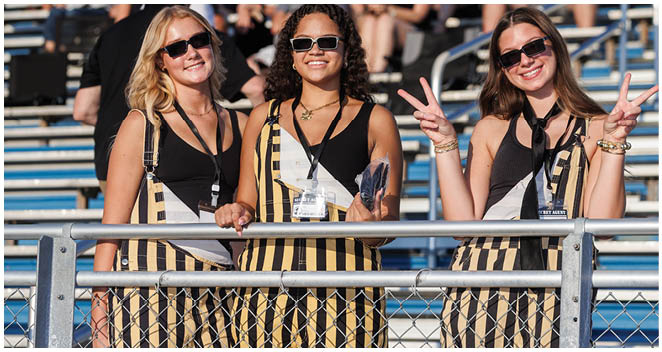 Three women wearing striped outfits and sunglasses. Description generated by AI