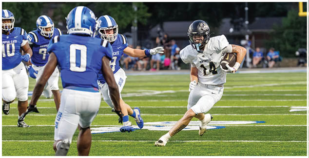 A football player in a blue jersey running on the field. Description generated by AI