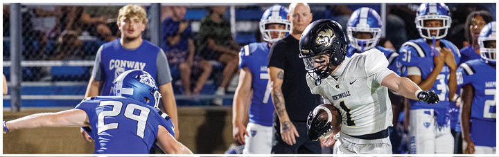 A football player is running with the ball. Description generated by AI