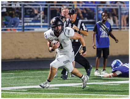 A football player running with the ball. Description generated by AI