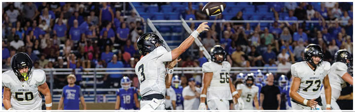 A football player catching a ball. Description generated by AI