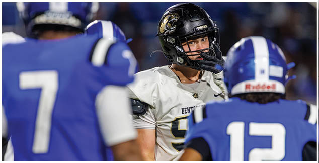 A football player wearing a white and black uniform. Description generated by AI