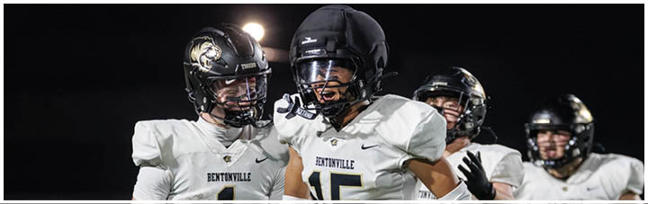 A group of football players wearing white uniforms. Description generated by AI