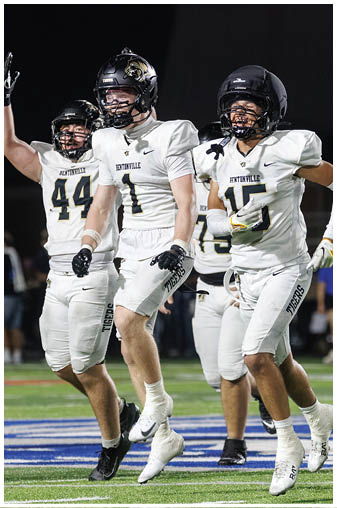 A group of football players celebrating a touchdown. Description generated by AI