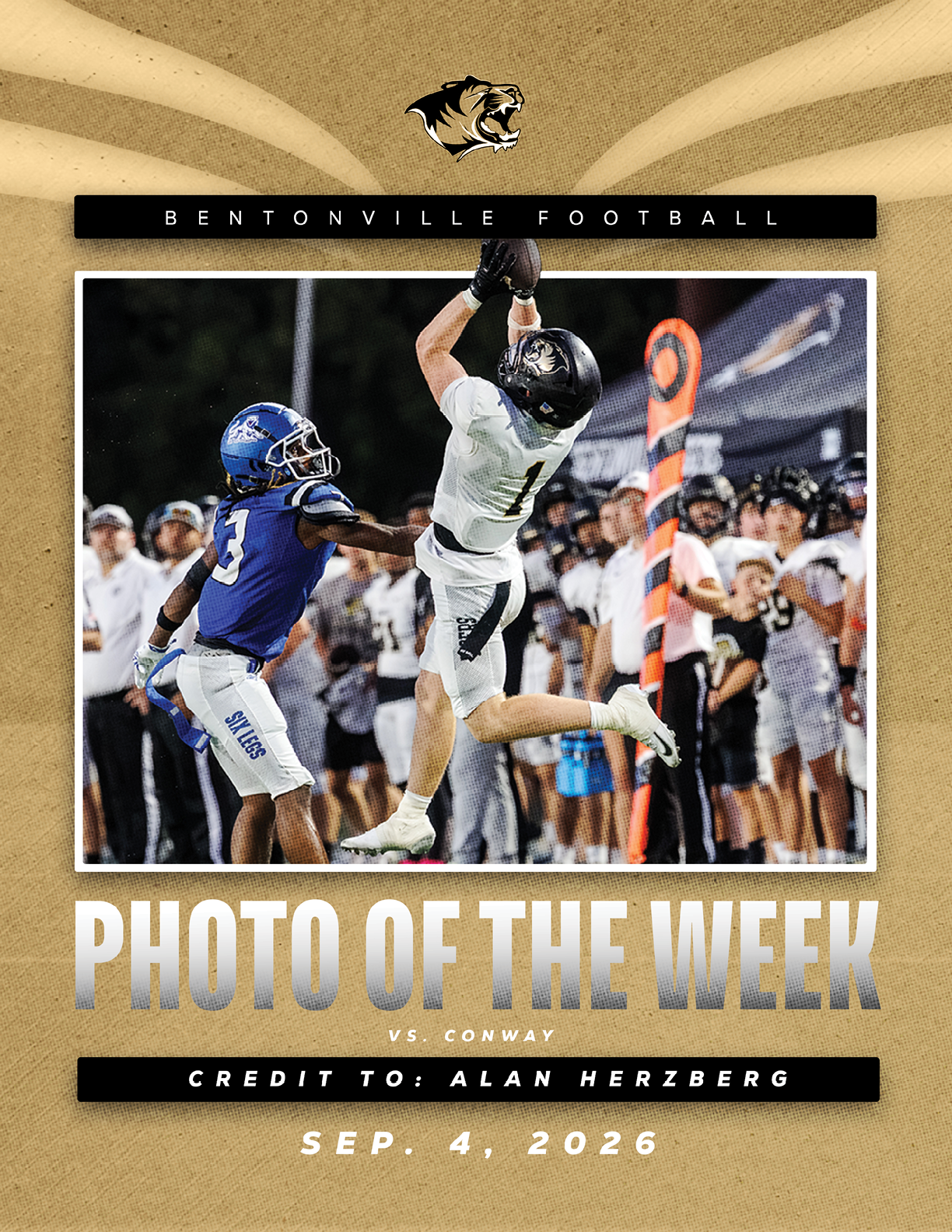 A football player in a white jersey catching a ball. Description generated by AI