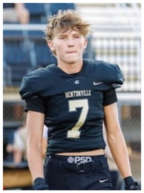 A football player wearing a black and gold jersey with the number 7 on it. Description generated by AI