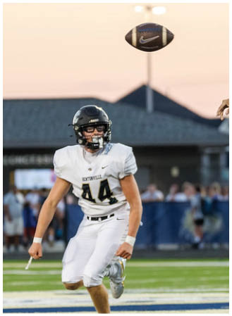 A man is kicking a soccer ball on a field. Description generated by AI