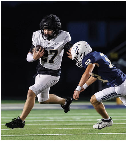 A football player wearing a black helmet and white jersey. Description generated by AI
