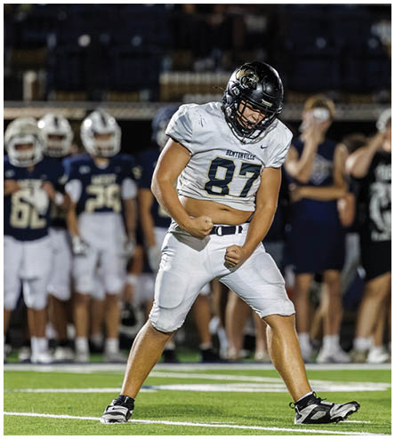 A football player wearing a black helmet and white jersey. Description generated by AI