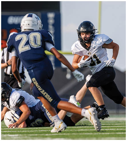 A football player wearing a black helmet and white jersey. Description generated by AI