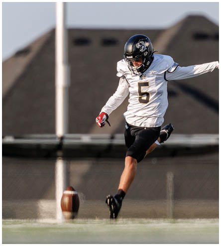 A football player wearing a black helmet and white jersey. Description generated by AI