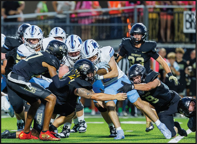 A group of football players in black and white uniforms are on the field. AI generated content