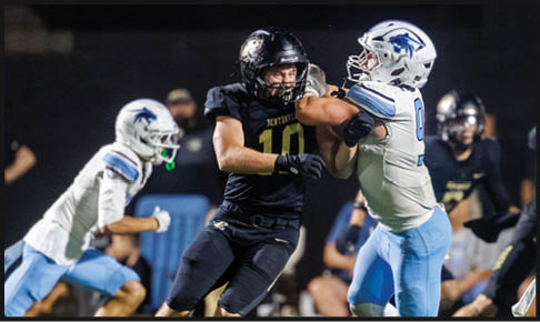 Two men wearing football uniforms are hugging each other on a field. AI generated content