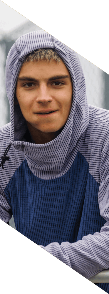 A young man wearing a football uniform is smiling and laughing. AI generated content