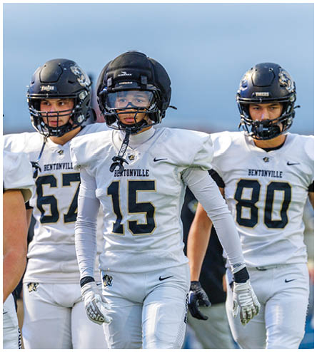 A football player wearing a black helmet and white jersey. Description generated by AI