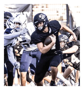 A football player in a black jersey is running with the ball. Description generated by AI