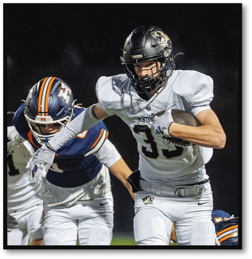 Two football players wearing black jerseys with the number 11 on them. Description generated by AI
