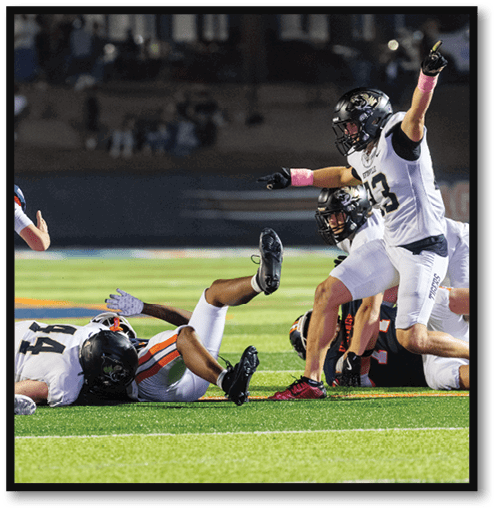 Two football players wearing black jerseys with the number 11 on them. Description generated by AI