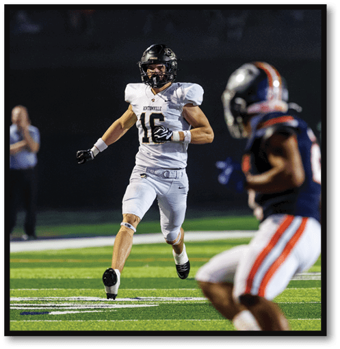 A group of men wearing black and white jerseys. Description generated by AI